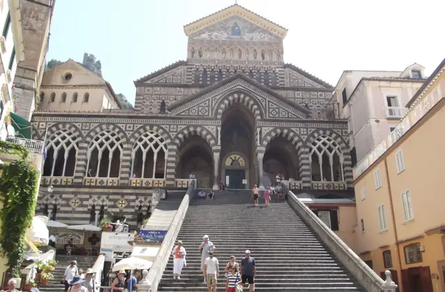 The staircase and striped facade of Amalfi Cathedral in Piazza Duomo