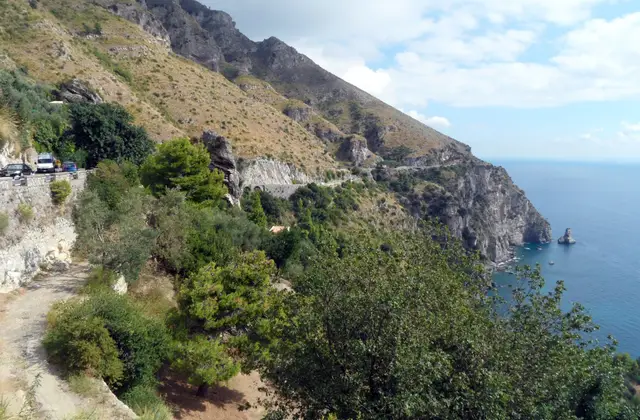 Aerial view of the Amalfi Coast with the towns above the sea and the road cut into the cliff