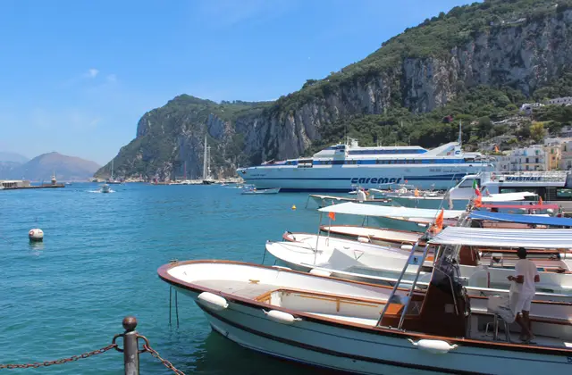 Marina Grande harbour on Capri with yachts and boats moored below the island's houses