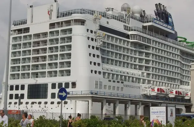 Cruise ship moored alongside the quay in the port of Salerno with the coast behind