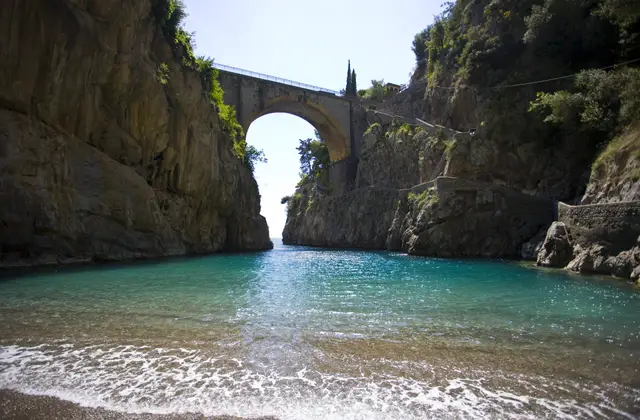 The Fiordo di Furore with the coast road bridge above the beach and the old fishermen's houses