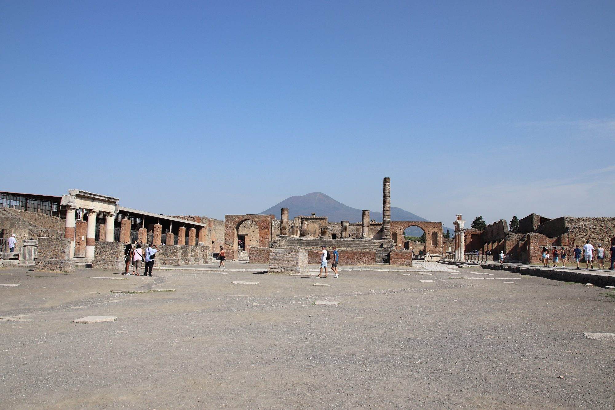 The ruins of Pompeii with Vesuvius behind them on a clear morning