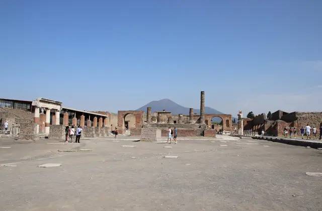 The ruins of Pompeii with Vesuvius behind them on a clear morning