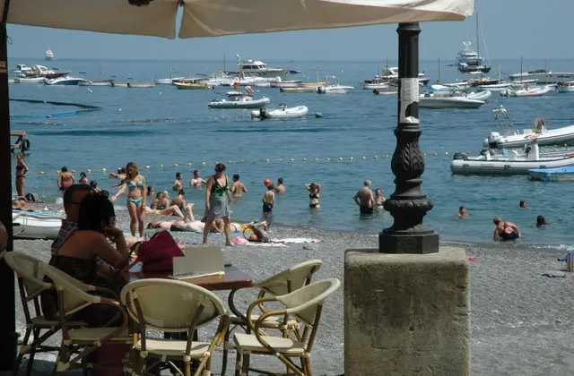 Wooden gozzo hauled up on a beach on the Amalfi Coast ready for hire