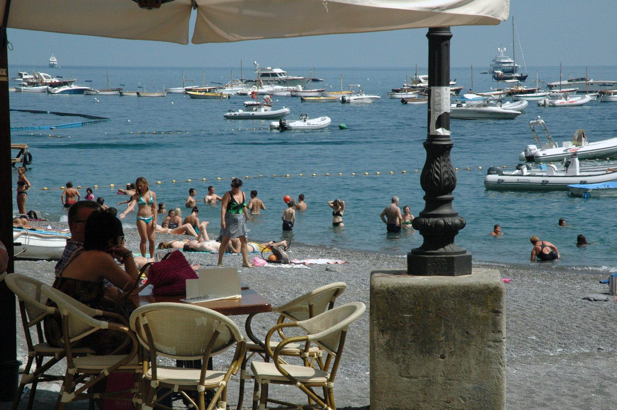 Wooden gozzo hauled up on a beach on the Amalfi Coast ready for hire