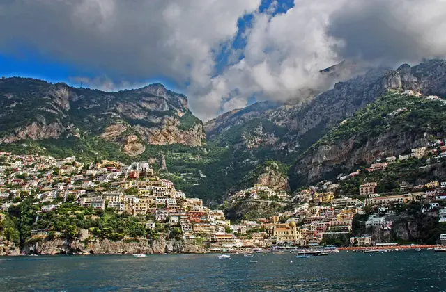 Positano photographed from the sea, its coloured houses climbing the cliff