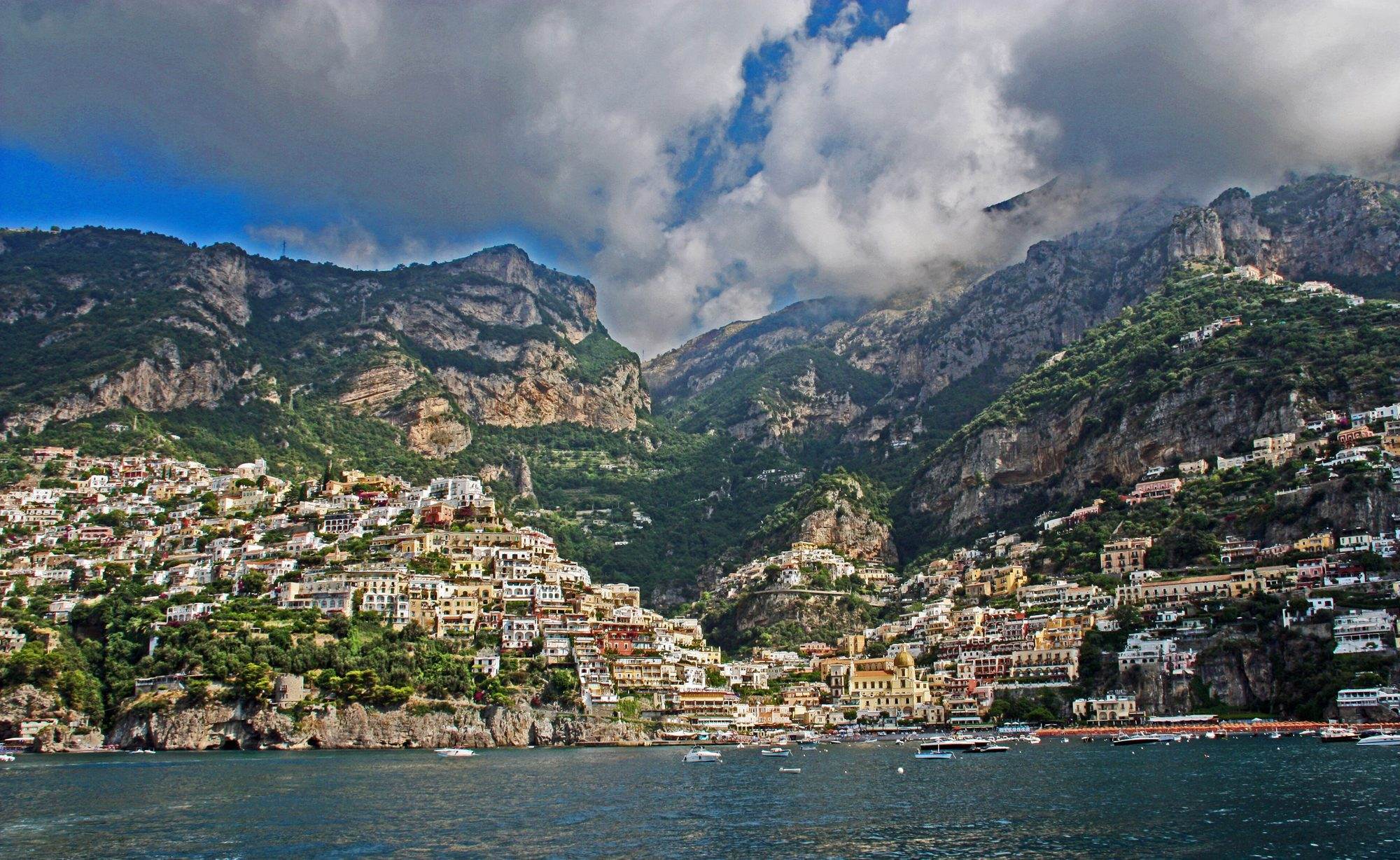 Positano seen from the water, its coloured houses climbing from Spiaggia Grande towards the Lattari mountains