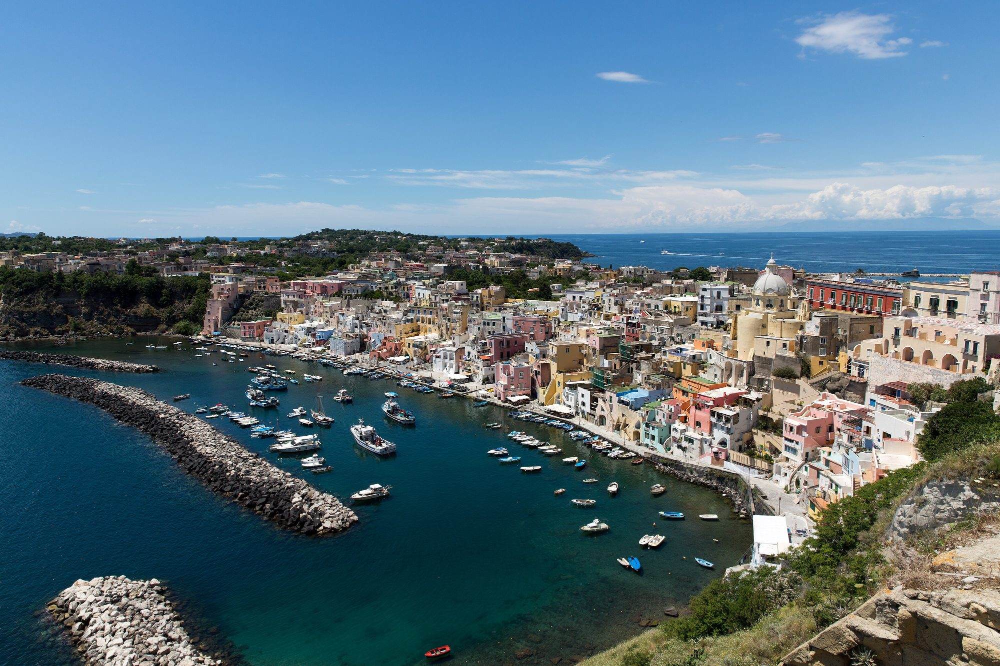 Colourful fishing boats moored in the harbour of Marina Corricella on Procida