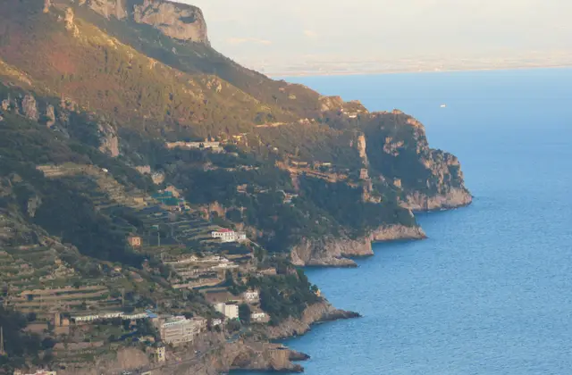 Sunset over the sea on the Amalfi Coast seen from a boat with the sun low on the horizon