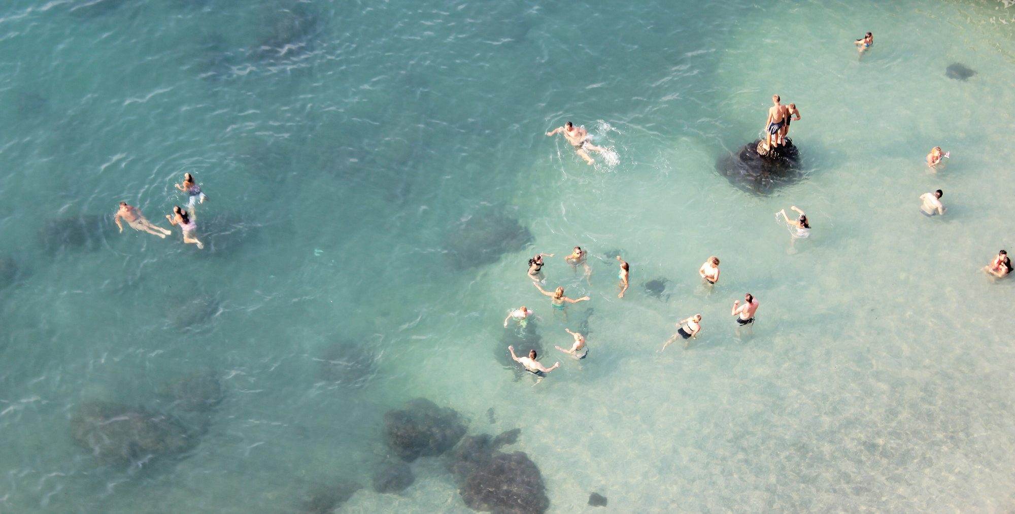 Snorkeller in clear water along the rocky shoreline of the Amalfi Coast