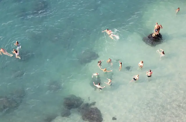 Snorkeller in clear water along the rocky shoreline of the Amalfi Coast
